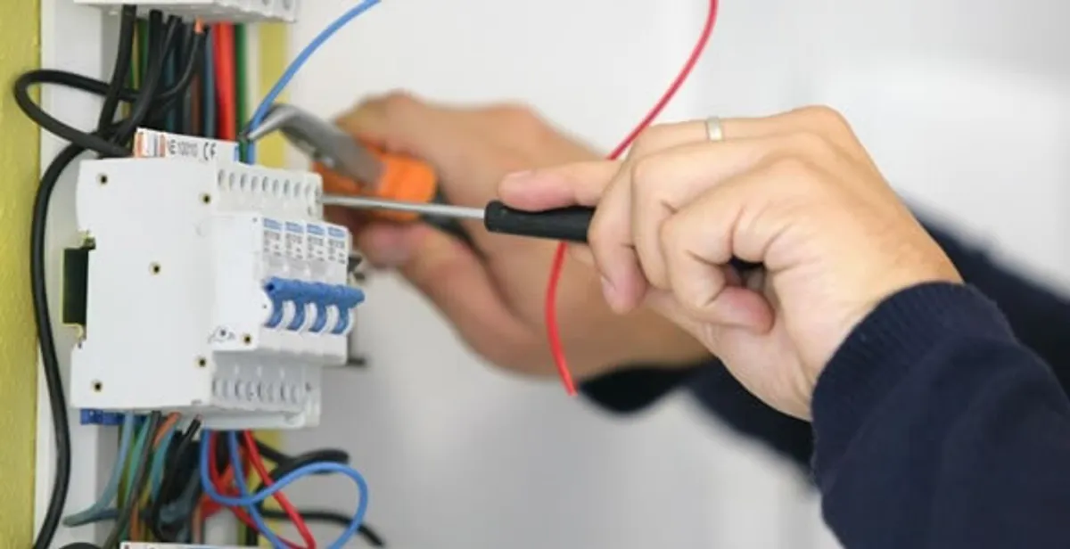 Electrician installing and adjusting circuit breakers in an electrical panel in Myrtle Beach, SC