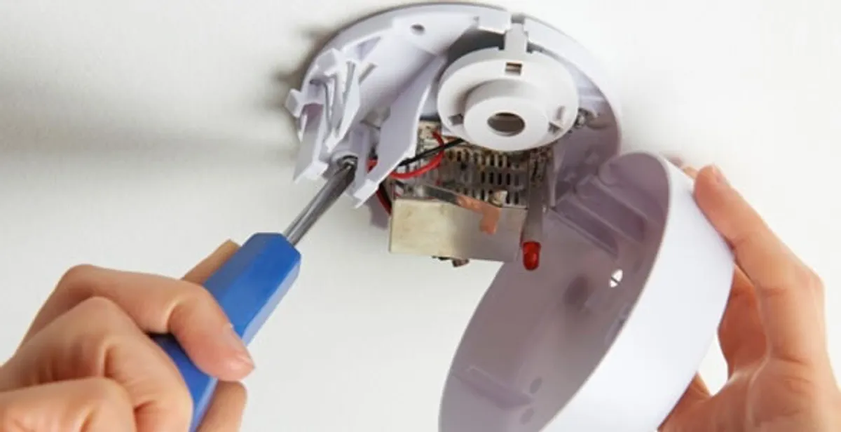 Certified technician wiring smoke detector during installation in Myrtle Beach, SC